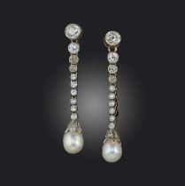A pair of natural pearl and diamond earrings, early 20th century, each designed as a graduated