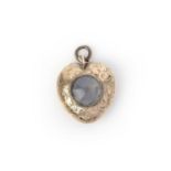 A gold and chalcedony pendant, 19th century and later, designed as a heart engraved with foliate