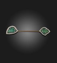 An Art Deco emerald, ruby and diamond jabot pin, France, 1920s, of Indian inspiration, each end