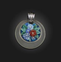 An unusual Art Deco carved hardstone, enamel and diamond pendant, 1930s, of circular outline,