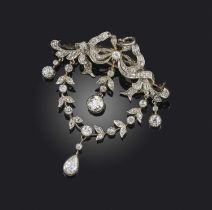 A Belle Epoque diamond brooch, set with three articulated diamonds diamond drops with a diamond-