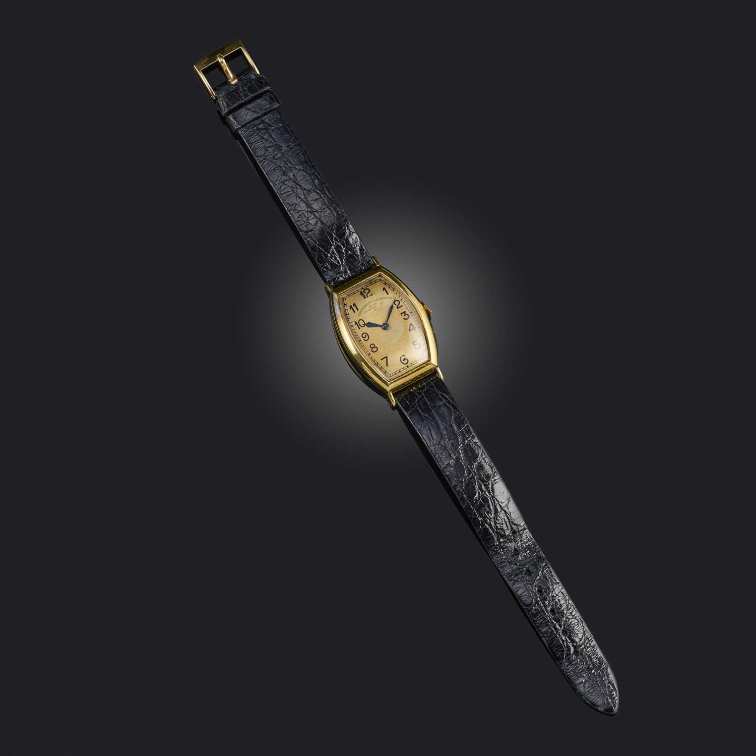 Patek Philippe, a gentleman's gold dress watch, mid 20th century, tonneau-shaped gilt dial with
