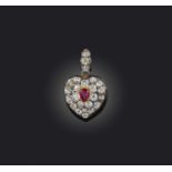 A ruby and diamond locket pendant, designed as a heart, set with cushion-shaped diamonds and a