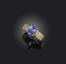 A tanzanite and diamond ring, set with an oval tanzanite within diamond-set shoulders in 14ct