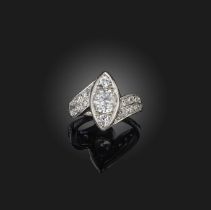 A diamond ring, mid 20th century, the centre of navette-shaped design, set with circular-cut