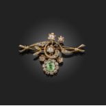 A demantoid garnet and diamond brooch, late 19th century, of floral design, set with a cushion-shape