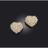 A pair of cultured pearl earrings, each designed as a heart, set with seed pearls, mounted in