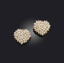 A pair of cultured pearl earrings, each designed as a heart, set with seed pearls, mounted in