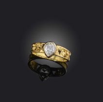 Φ Φ John Donald, a diamond ring, collet-set with a pear-shaped diamond weighing approximately 0.50