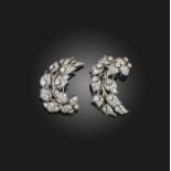 A matching pair of diamond brooches, of foliate scroll design set with graduated circular-cut