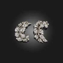 A matching pair of diamond brooches, of foliate scroll design set with graduated circular-cut