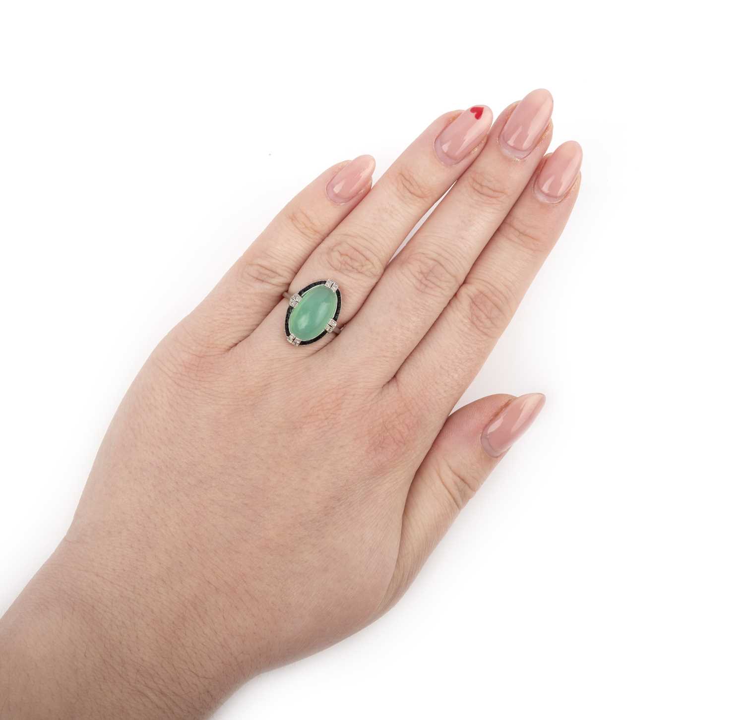 An Art Deco chrysoprase, onyx and diamond ring, 1920s, set with a chrysoprase cabochon, within a - Image 2 of 2