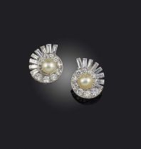 A pair of natural pearl and diamond earrings, mid 20th century, each of spiral design, centring on a
