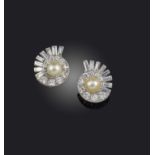 A pair of natural pearl and diamond earrings, mid 20th century, each of spiral design, centring on a