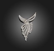 A diamond brooch, 1950s, of abstract scroll design, set with single- and circular-cut diamonds,
