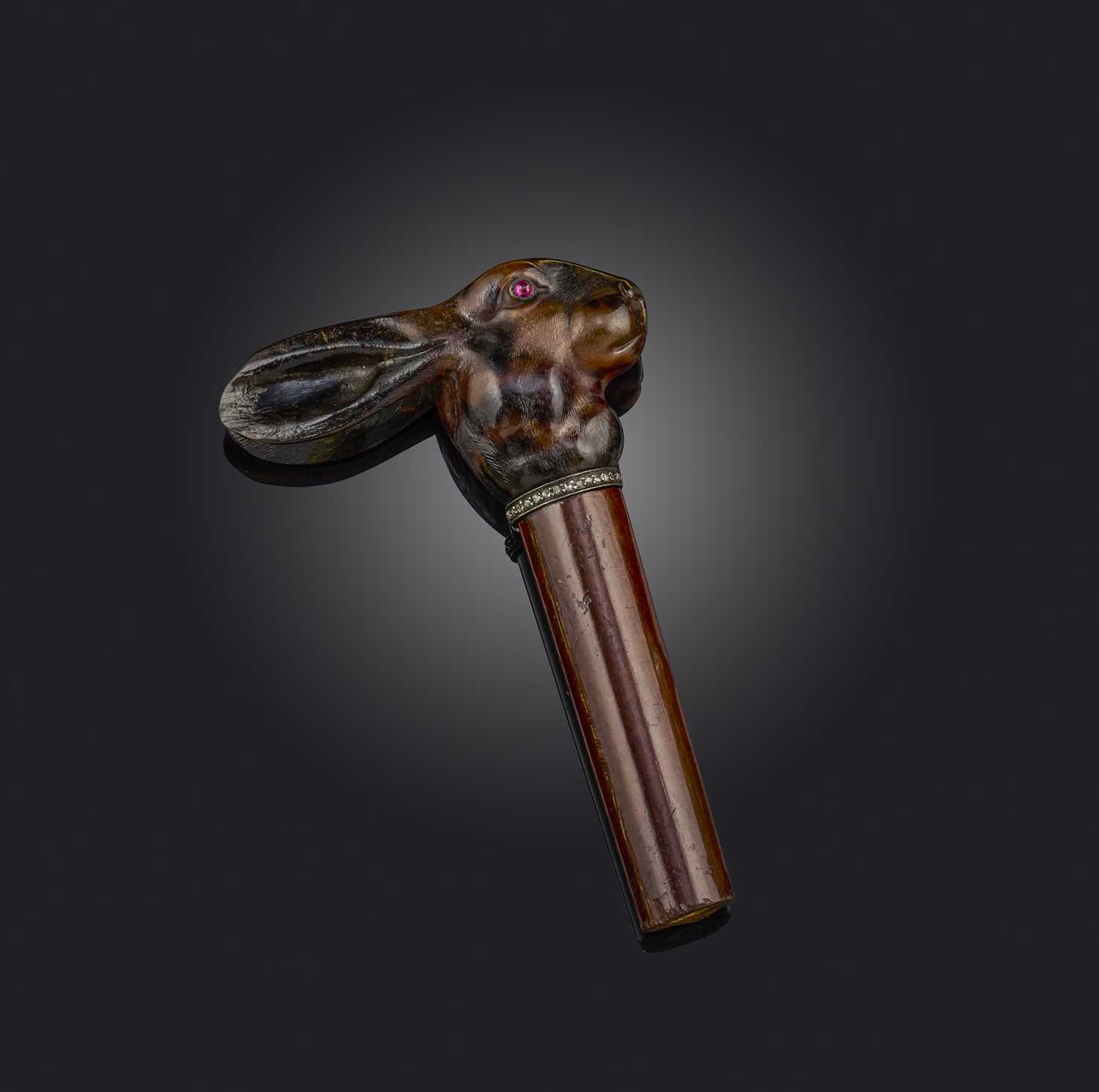 λ A late 19th century carved tortoiseshell cane handle, designed as a hare with ruby cabochon eyes