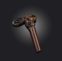 λ A late 19th century carved tortoiseshell cane handle, designed as a hare with ruby cabochon eyes