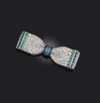 Henri Picq, an Art Deco emerald, sapphire and diamond brooch, 1920s, naturalistically modelled as
