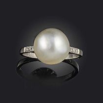 A natural pearl ring, early 20th century, set with a pearl measuring approximately 11.0-11.2 x 9.