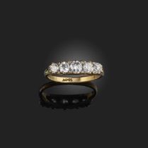 A diamond five stone ring, set with graduated old cushion-shaped diamonds in carved and pierced