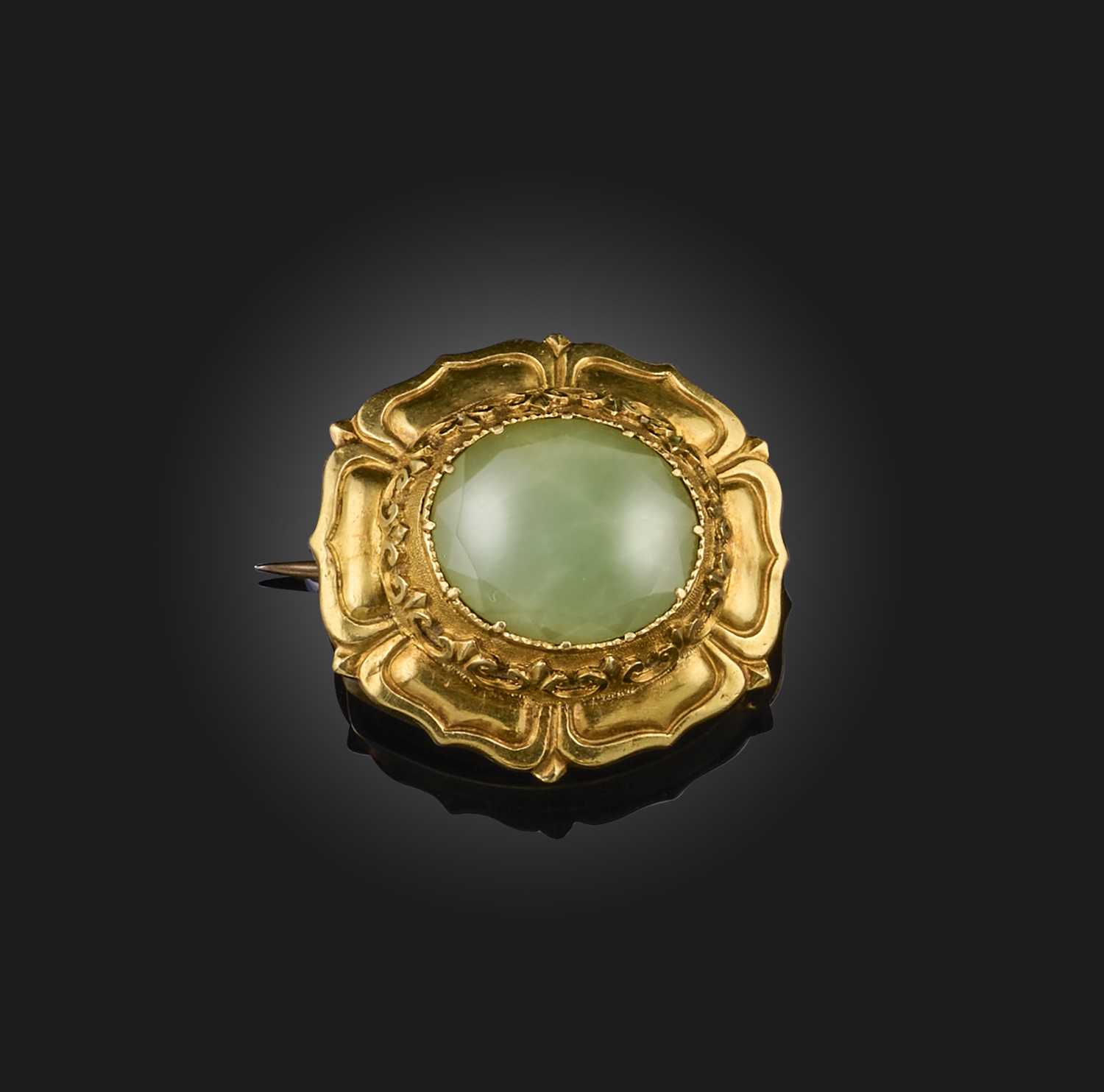 A Regency gold and chrysoprase brooch, the oval chrysoprase set within repousse gold border,