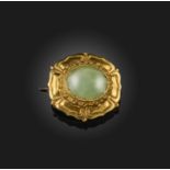 A Regency gold and chrysoprase brooch, the oval chrysoprase set within repousse gold border,