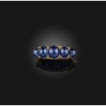 A late 19th century sapphire half hoop ring, set with graduated sapphire cabochons and diamond