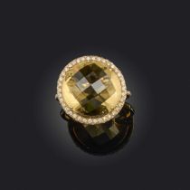 A citrine and diamond ring, set with a rose-cut citrine, within a border of brilliant-cut