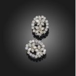 A pair of diamond cluster earrings, each set with a pair of diamond-set flowerheads set with