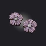 A pair of pink sapphire and diamond flower earrings, set with circular-cut diamonds and pink