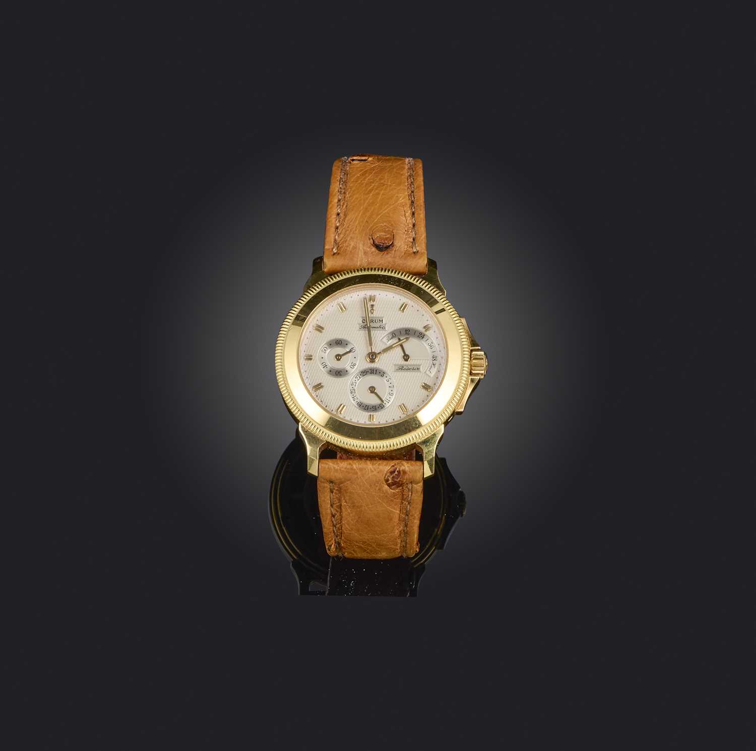 Corum, a gold 'Reverse de Marche' watch, ref.73.109.56, signed guilloché dial with subsidiary