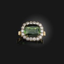 A green tourmaline and diamond ring, of cluster design, claw-set with a cushion-shaped green