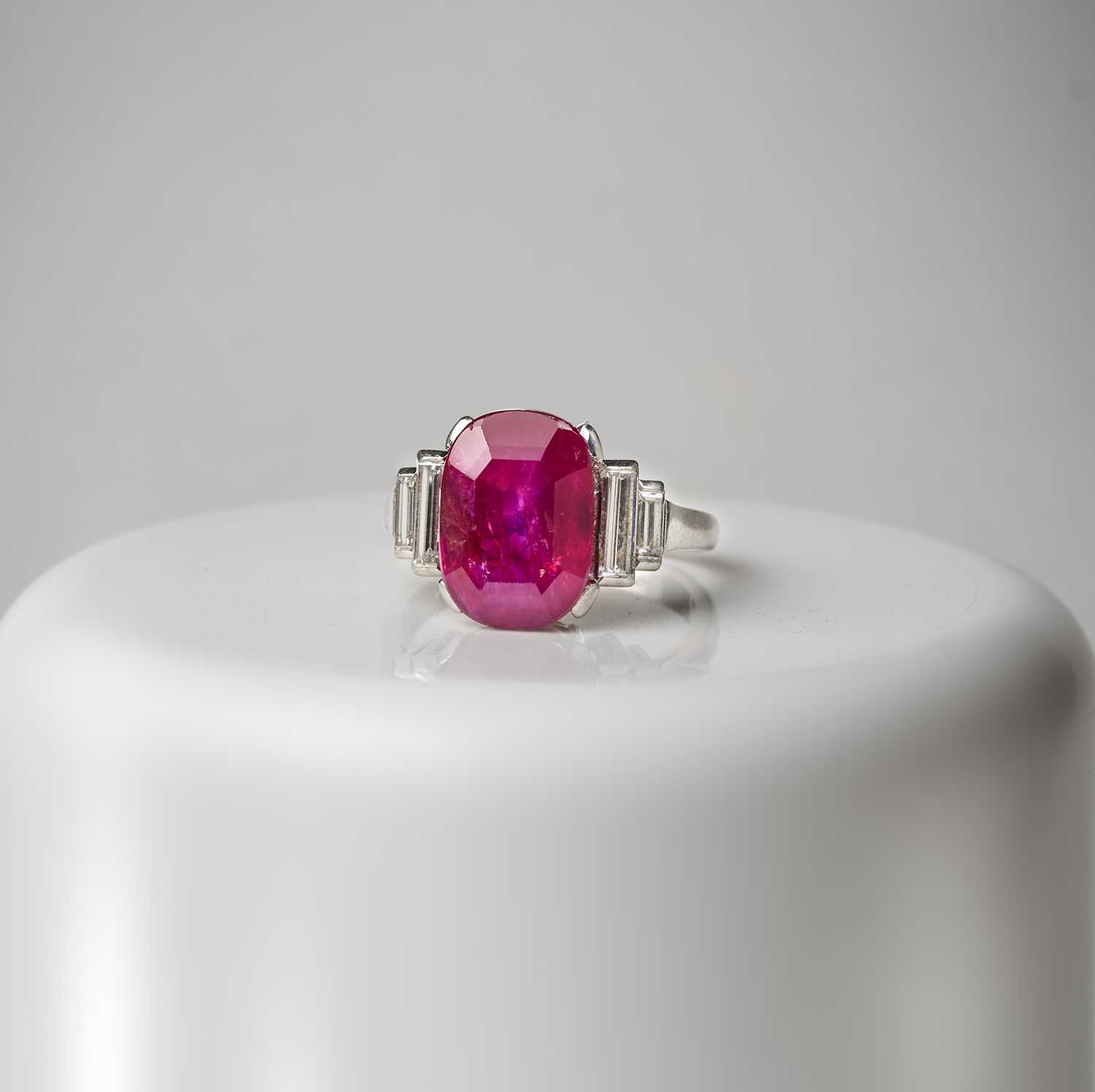 An impressive Art Deco ruby and diamond ring, 1920s, set with a cushion-shaped ruby weighing 5.
