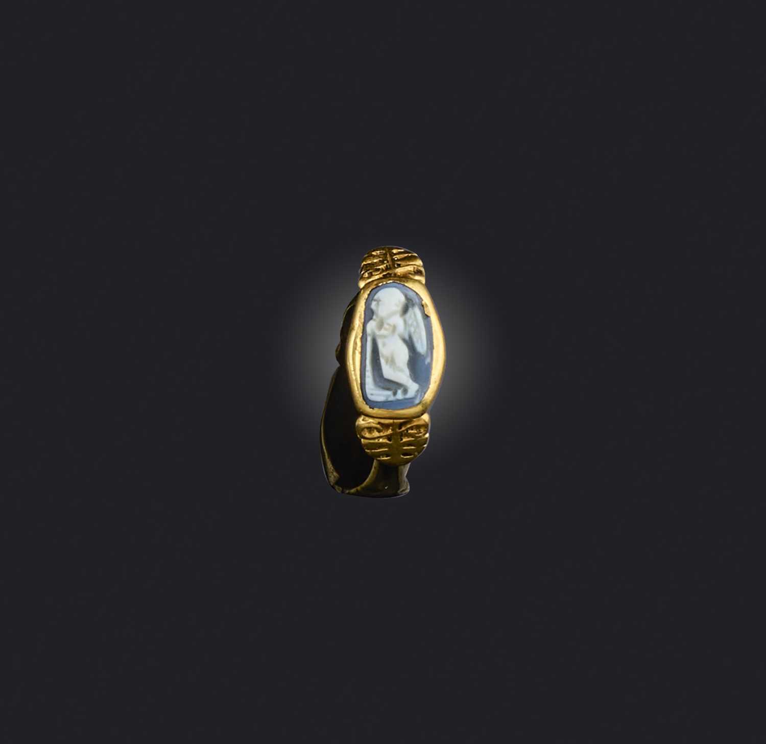 A rare Roman agate cameo ring, 3rd century AD, set with a blue-grey cameo of funerary theme