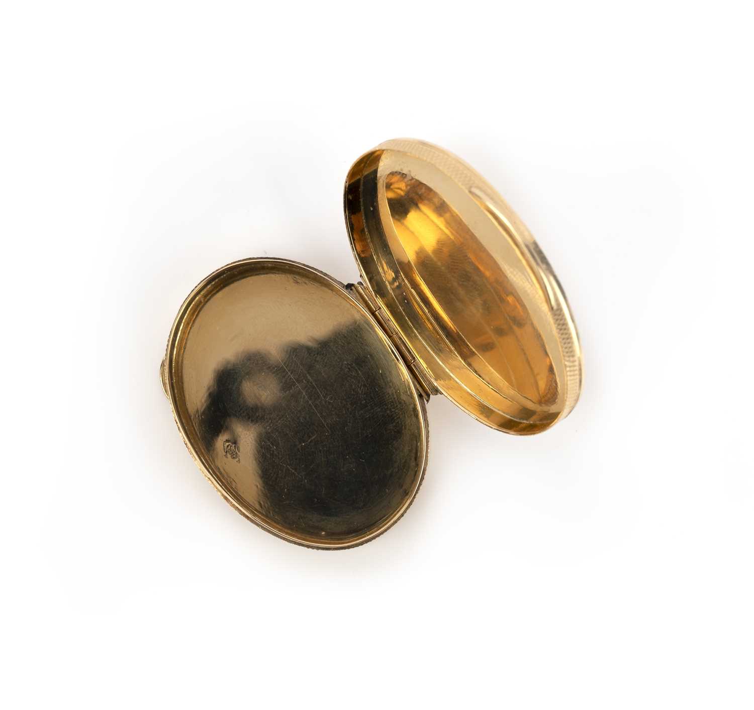 An oval gold pill box, with engine turned decoration, hinged opening, signed Cartier London and - Image 2 of 3