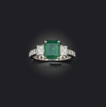 An emerald and diamond ring, claw-set with a step-cut emerald weighing approximately 1.60 carats,