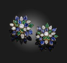 A pair of emerald, sapphire and diamond ear clips, each designed as a large openwork cluster, set