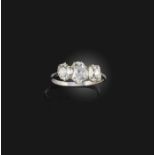 A diamond three-stone ring, early 20th century, set with three cushion-shaped diamonds, mounted in