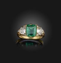 An emerald and diamond ring, early 20th century, set with a step-cut emerald, between shoulders