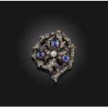 A Victorian sapphire and diamond brooch, late 19th century, designed as a foliate spiral, set with