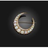 An opal and diamond brooch, late 19th century, designed as a crescent moon, set with graduated