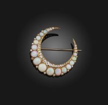 An opal and diamond brooch, late 19th century, designed as a crescent moon, set with graduated