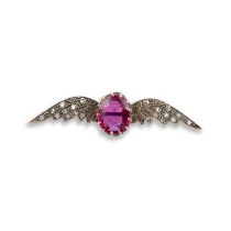 A synthetic ruby and diamond wings brooch, the oval synthetic ruby within diamond-set wings in gold,