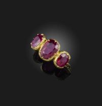 A ruby three-stone ring, set with three cushion-shaped rubies totalling approximately 4.00 carats,