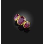 A ruby three-stone ring, set with three cushion-shaped rubies totalling approximately 4.00 carats,