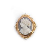 An onyx cameo brooch, late 19th century, set with an oval onyx cameo depicting a classical woman