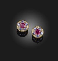 A pair of ruby and gem-set earrings, each of cluster design, set with a circular-cut ruby within a