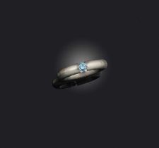 Niessing, a blue diamond 'Spannring' ring, the brilliant-cut blue diamond weighing approximately 0.