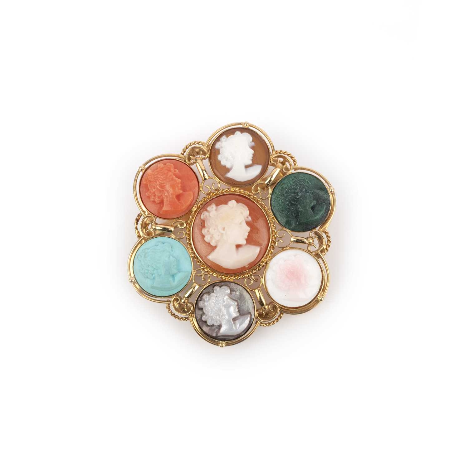 λ A cameo brooch, designed as a cluster of seven cameos depicting a girl in profile, carved in conch