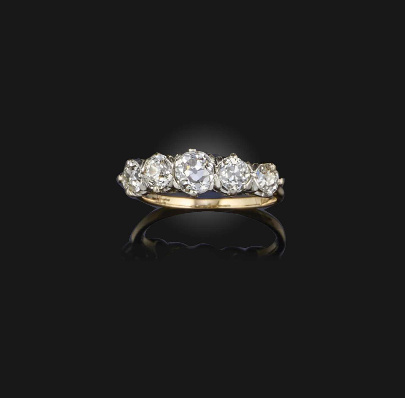 A five-stone diamond ring, designed as a line of graduated circular-cut diamonds totalling